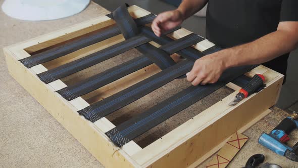 A Worker Makes a Sofa in a Furniture Factory