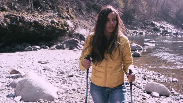 Young Woman During A Nordic Walking Hiking On Board A River