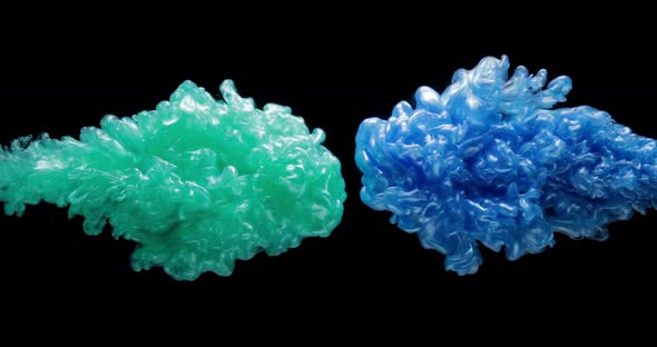 Green and Blue Fluid Paints Are Exploding, Creating Clouds of Mixed Colors
