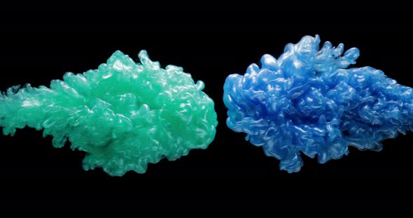 Green and Blue Fluid Paints Are Exploding, Creating Clouds of Mixed Colors alt