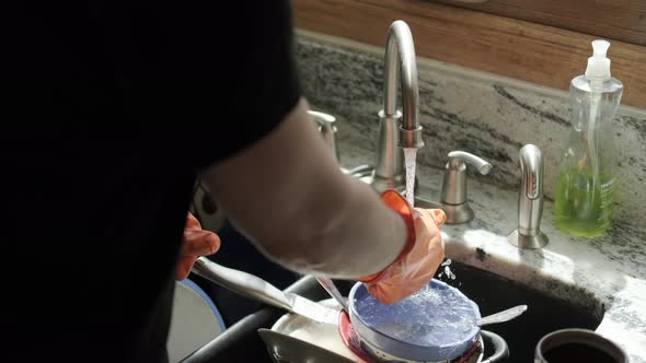 Hands in Orange Gloves Wash Dishes in the Kitchen Version 5