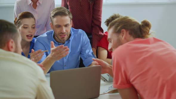 Young Leader Working with Colleagues Meeting Room