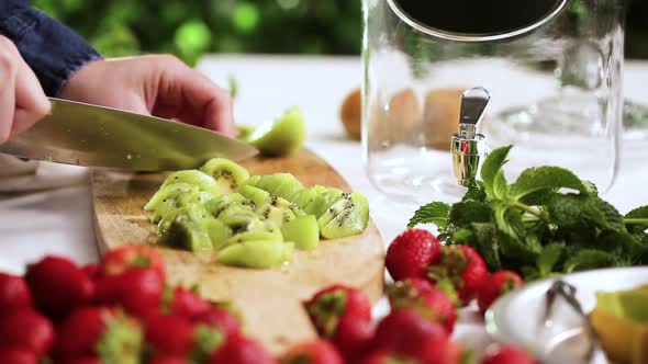 Step by step. Slicing fresh organic kiwi for infused water.