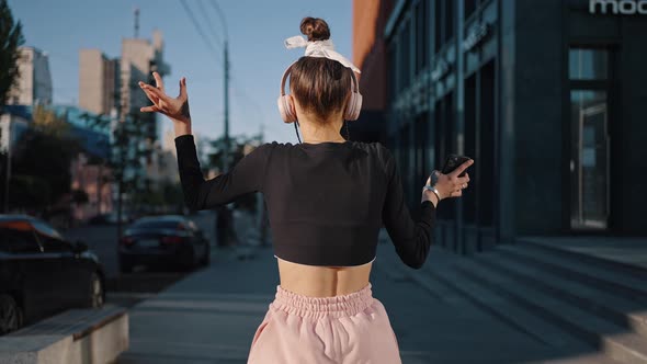 Young Woman Enjoys Life Being Dancer and Shows Moves in City