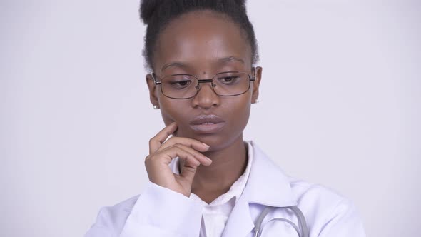 Face of Young Sad African Woman Doctor Thinking and Looking Down