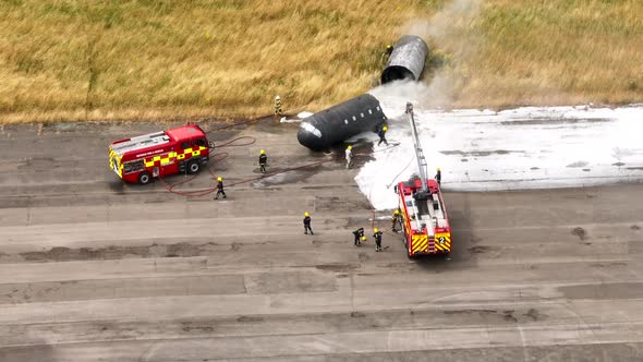 Firefighters Training to Tackle a Fire of a Dummy Aircraft