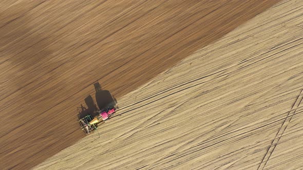 Tractor Planting Seeds Of Grain Crops In Agricultural Field Aerial Top View