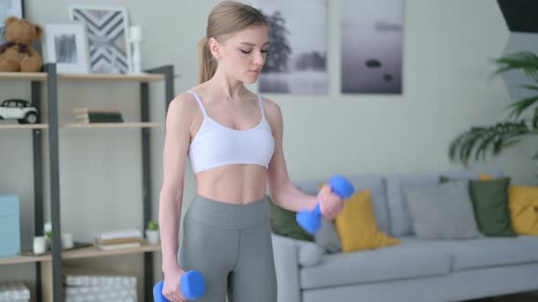 Close Up of Athletic Young Woman Exercising with Dumbbells
