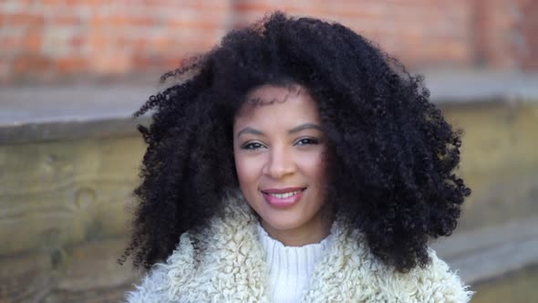 Portrait of Beautiful African American Woman Looking at Camera with Smile Standing Outdoors Spbi