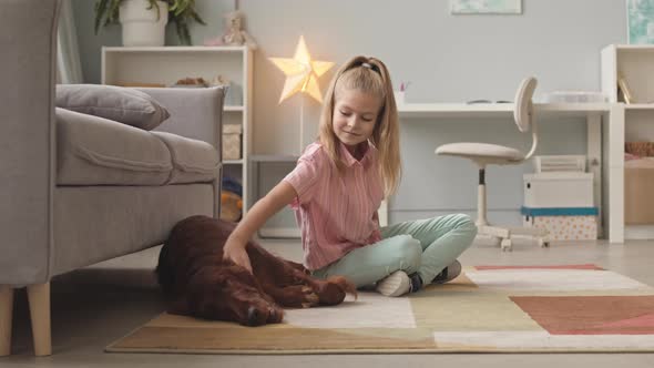 Happy Girl Petting and Hugging Her Dog