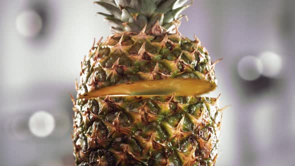 Half Pineapple Falling and Splashing on White Background