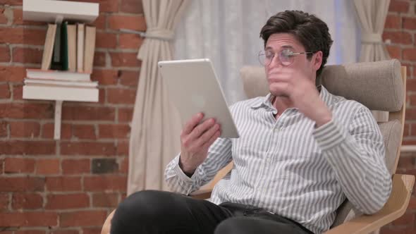 Middle Aged Man Talking on Video Call on Tablet on Sofa