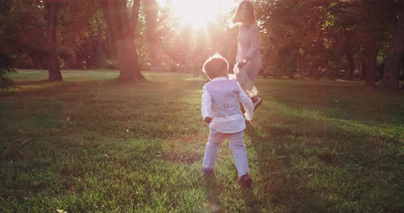 Little Cute Boys in the Stylish Suit Running After