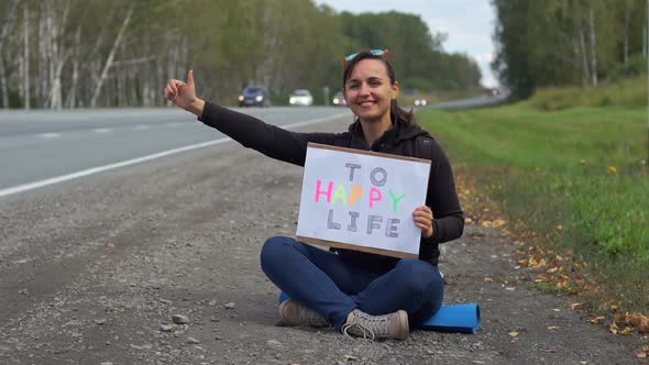 Cheerful Pretty Woman Traveling Hitchhiking