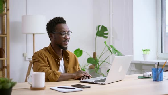 African Man Conducts Computer Meeting Via Video Call at Home Spbas