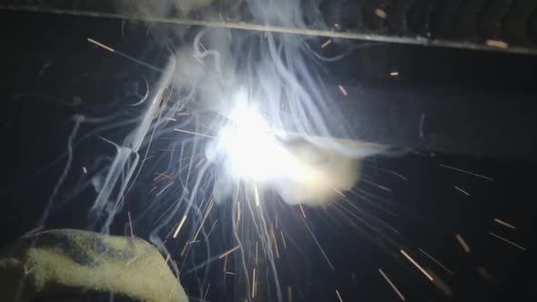 Close-up hand of Metal welder working with an arc welding machine.
