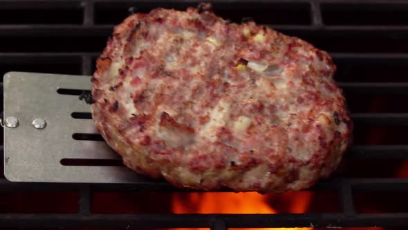 Closeup of the Homemade Burger Cutlet Made of Meat Flipped on the Grill