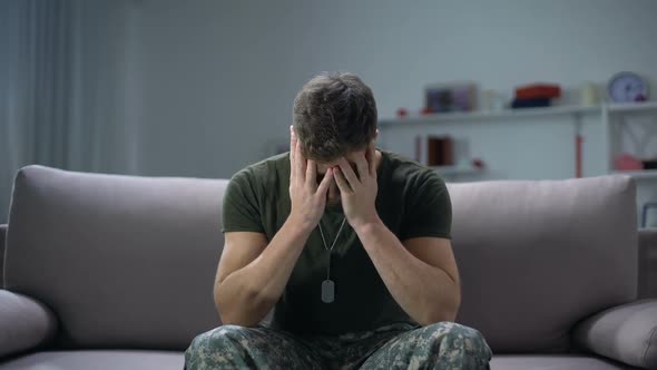 Nervous Male Military Suffering Depression, Sitting Alone at Home, PTSD Concept