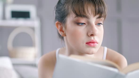 Closeup Portrait Young Teenager Woman Enthusiastically Reading Book at Home Interior