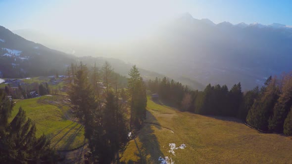 Aerial View of Cozy Village on Green Mountain Hill, Magic Hour in Austrian Alps