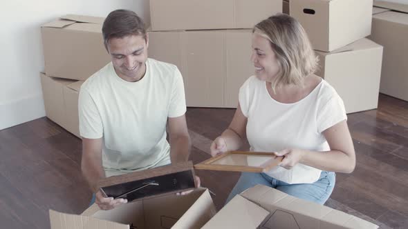 Happy Couple Talking While Packing Things for Moving
