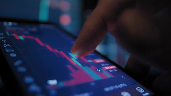 Businessman Analyzes the Stock Market on a Smartphone