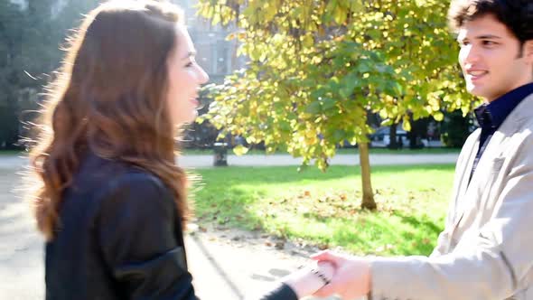 Young beautiful couple in love dancing outdoor in the city back light