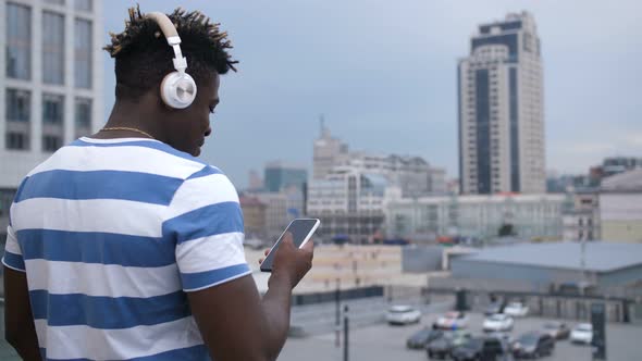 Hipster with Smart Phone Chatting Online Outdoors