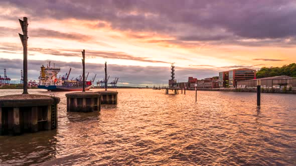 Stunning day to night time lapse of Port of Hamburg and Elbe River with huge container ships passing