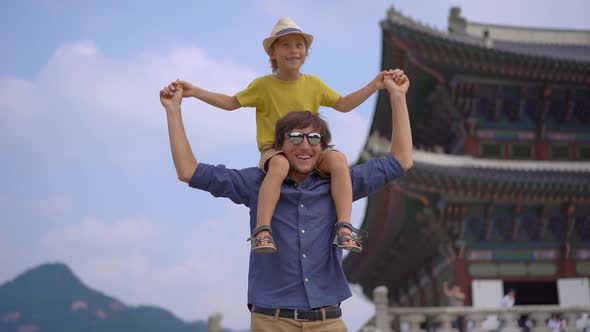 Young Man and His Little Son Visit Ancient Palace in Seoul, South Korea. Travel To Korea Concept