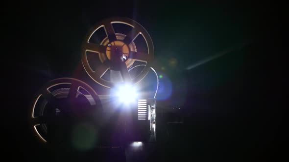 Film Projector Backlit From Behind Light Lamp. Dark Background Studio