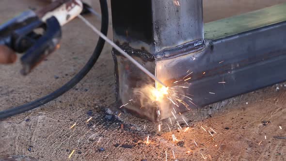 hand of worker welding metal