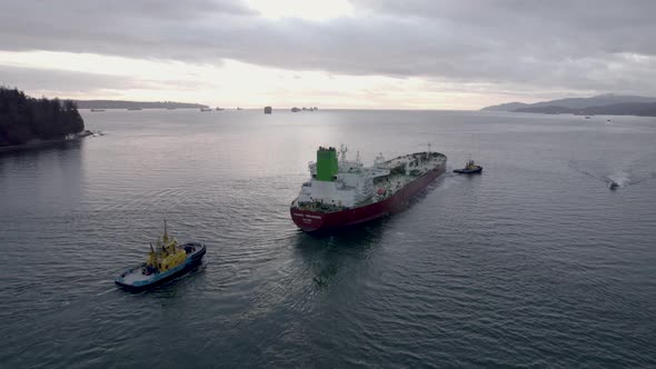 Barge and pilot boats sailing on Burrard Inlet fjord, Vancouver in Canada. Aerial tracking