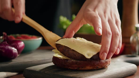 Chef Cooking Burger Putting Meat Chop with Cheese on Lettuce Closeup Making Sandwich Fast Food