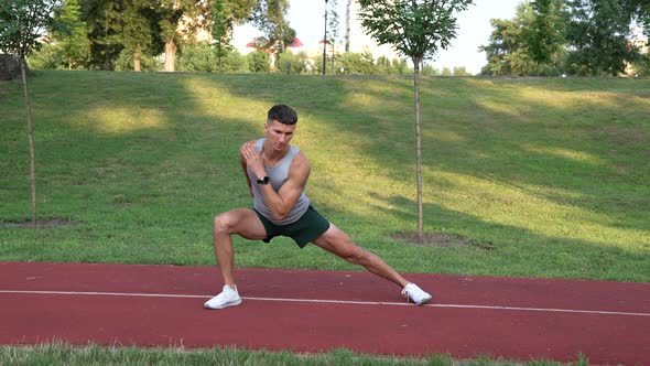 Athletic Man Warming Up with Side Lunge Exercise Outdoor Sport