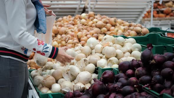 Young Woman Buying Onions in a Supermarket