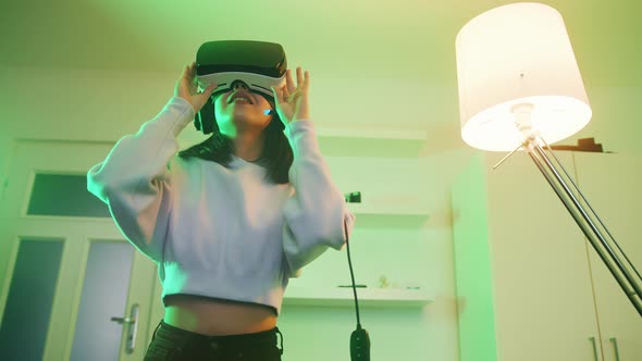 Young Asian Woman Experiencing Virtual Reality Alone at Home