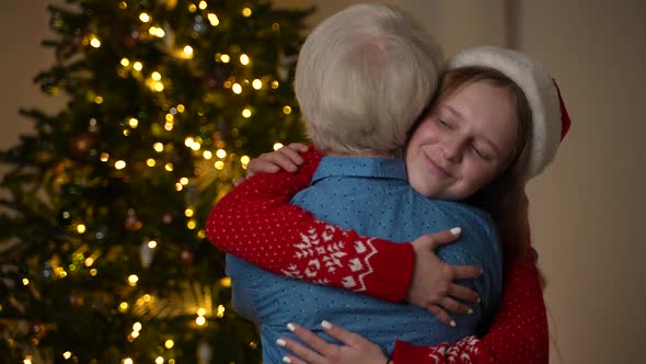 Loving Teen Girl Hugging Grandma on New Year's Eve