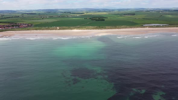 Aerial footage of the seaside coastal town of the village of Seahouses, a large village in the UK