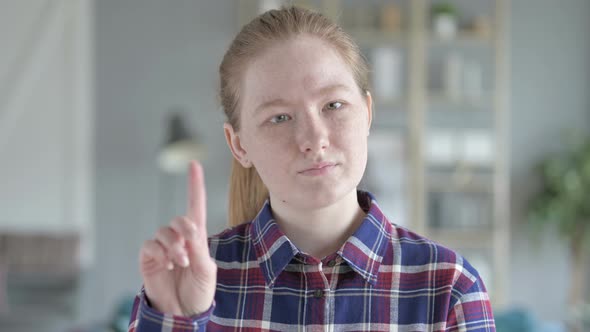 Close Up of Young Woman Saying No With Finger Gesture