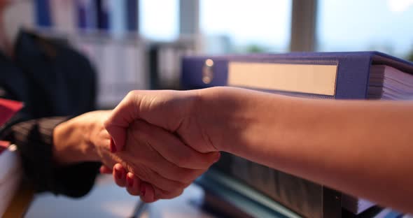 Lawyer Shakes Hands with Client in Courtroom Closeup