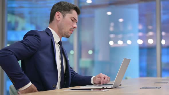 Businessman Having Back Pain at Work