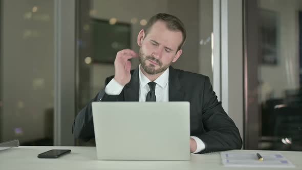 Tired Young Businessman Having Neck Pain at Night