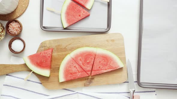 Step by step. Slicing watermelon into wadges to make watermelon ice pops.