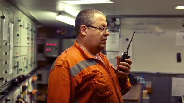 Marine Engineer Working on Radio Communication at Engine Control Room