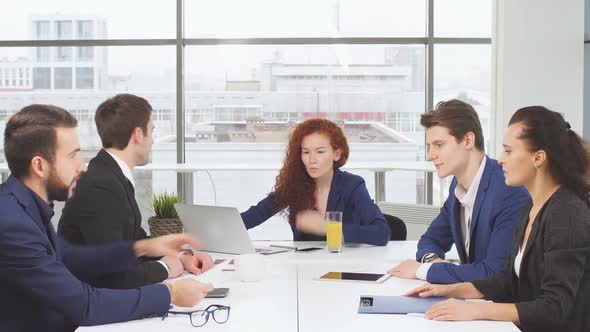 Young Office Employees of a Business Company Sharing a Table