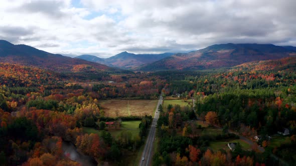 Aerial flythrough of Winding Road Through Autumn Trees with Fall Colors in New England