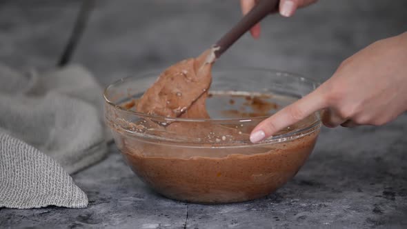 Female Hands Mixing the Chocolate Batter for Cake