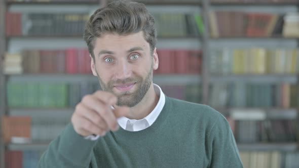 Ambitious Young Man Pointing with Finger and Inviting