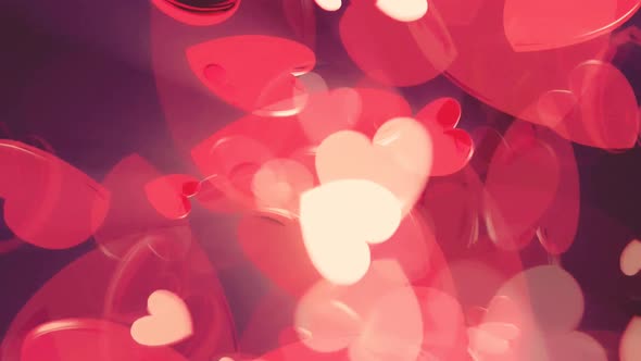 Abstract red hearts on dark background.